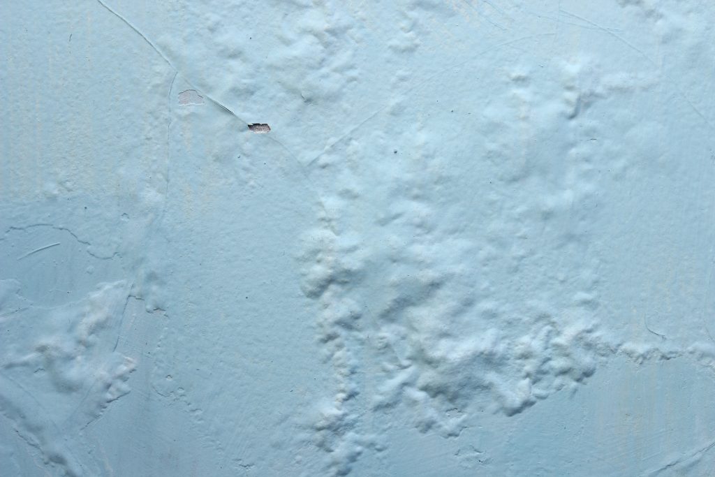 Paint peeling bubbling and blistering on walls in Somerset West coastal homes caused by damp salt poor preparation and coating failure
